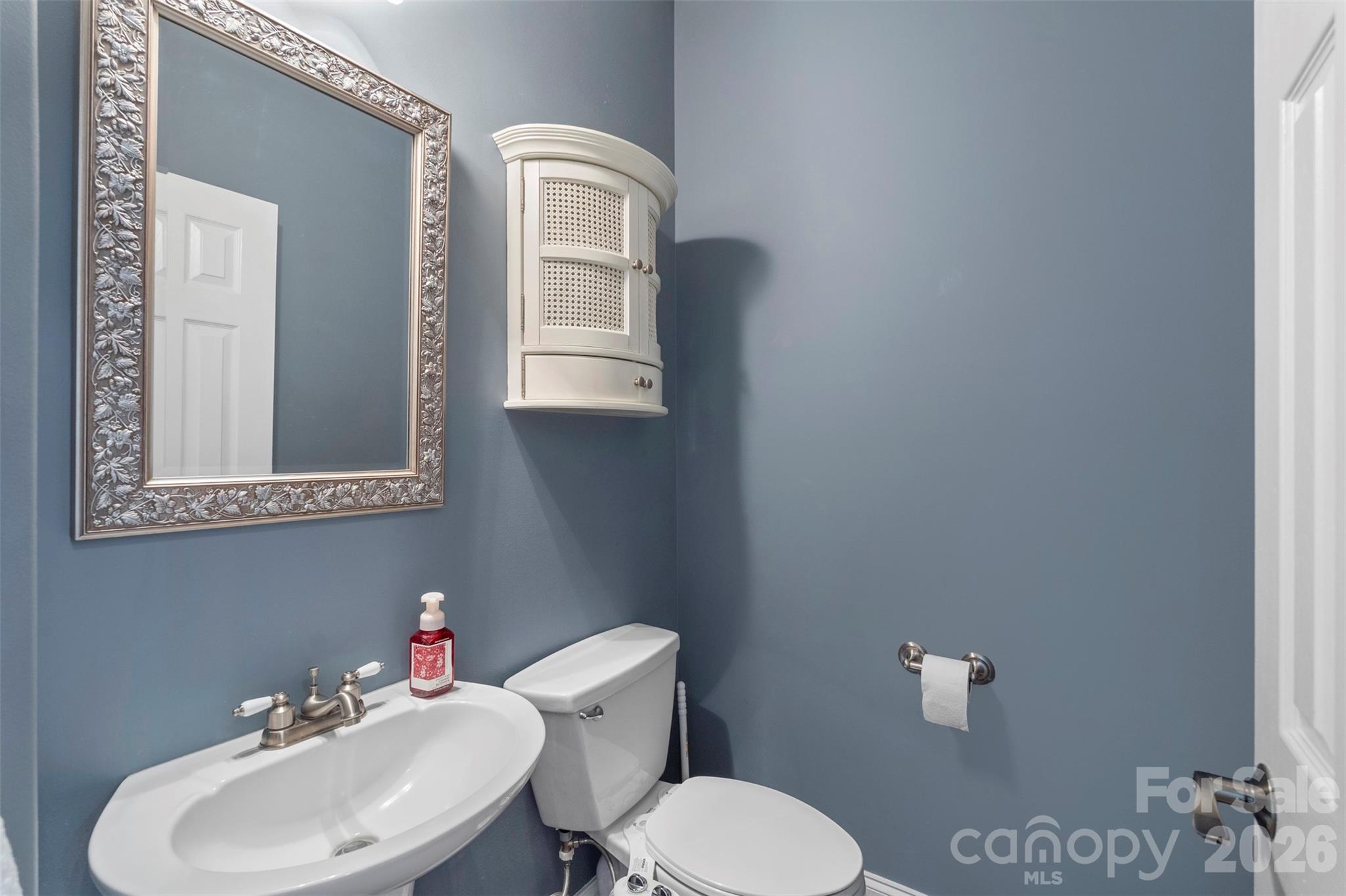 12711 Moores Chapel Road Charlotte, NC 28214 - Photo 35 of 48 a bathroom with a toilet sink and mirror