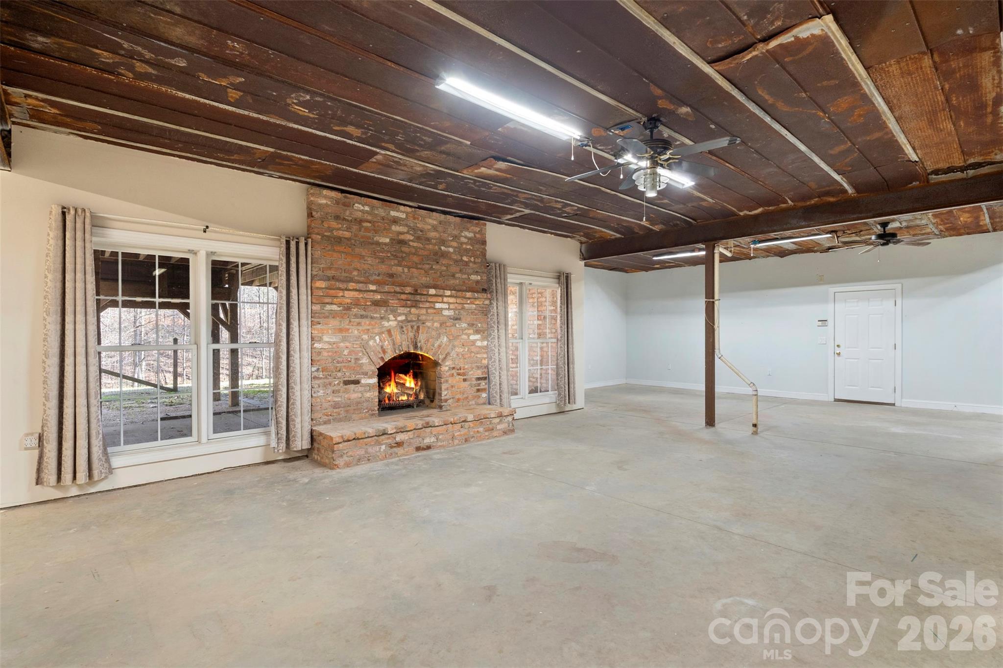 12711 Moores Chapel Road Charlotte, NC 28214 - Photo 43 of 48 a view of an empty room with a fireplace and a window