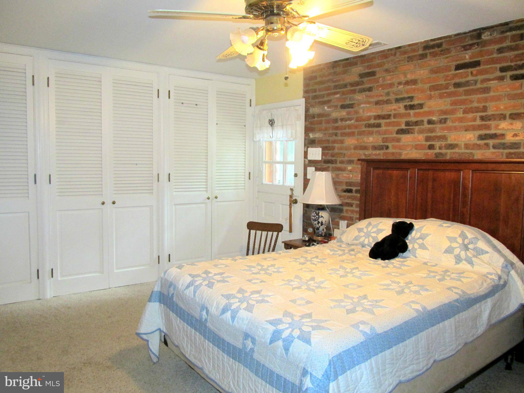 6206 Medora Road Linthicum, MD 21090 - Photo 17 of 30 a bedroom with a bed and a chandelier
