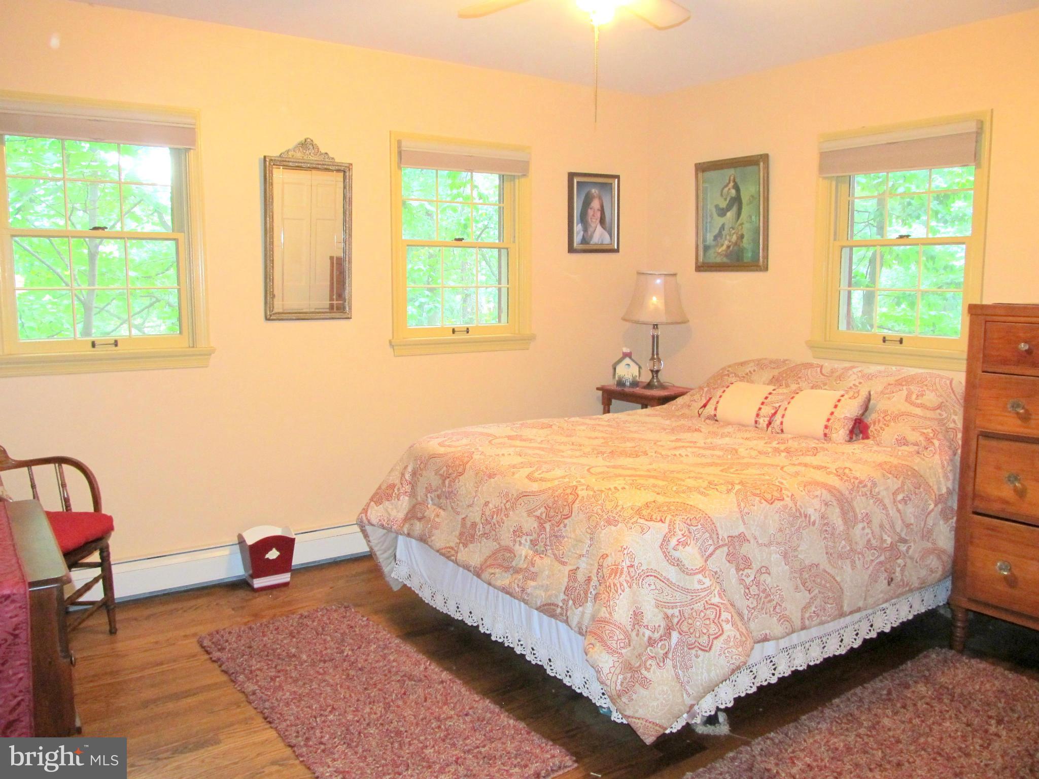 6206 Medora Road Linthicum, MD 21090 - Photo 19 of 30 a bedroom with a bed a table and chair