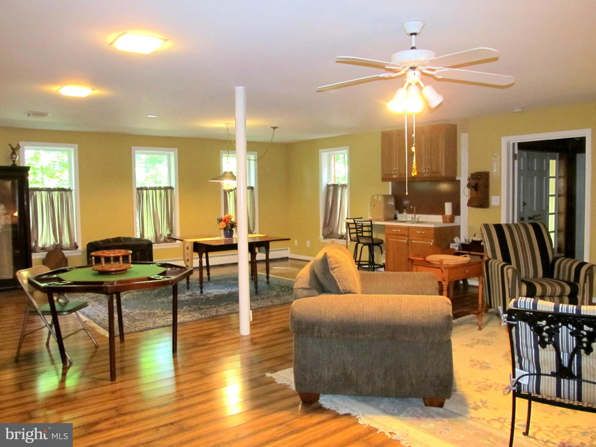 6206 Medora Road Linthicum, MD 21090 - Photo 23 of 30 a living room with couches and kitchen view with wooden floor
