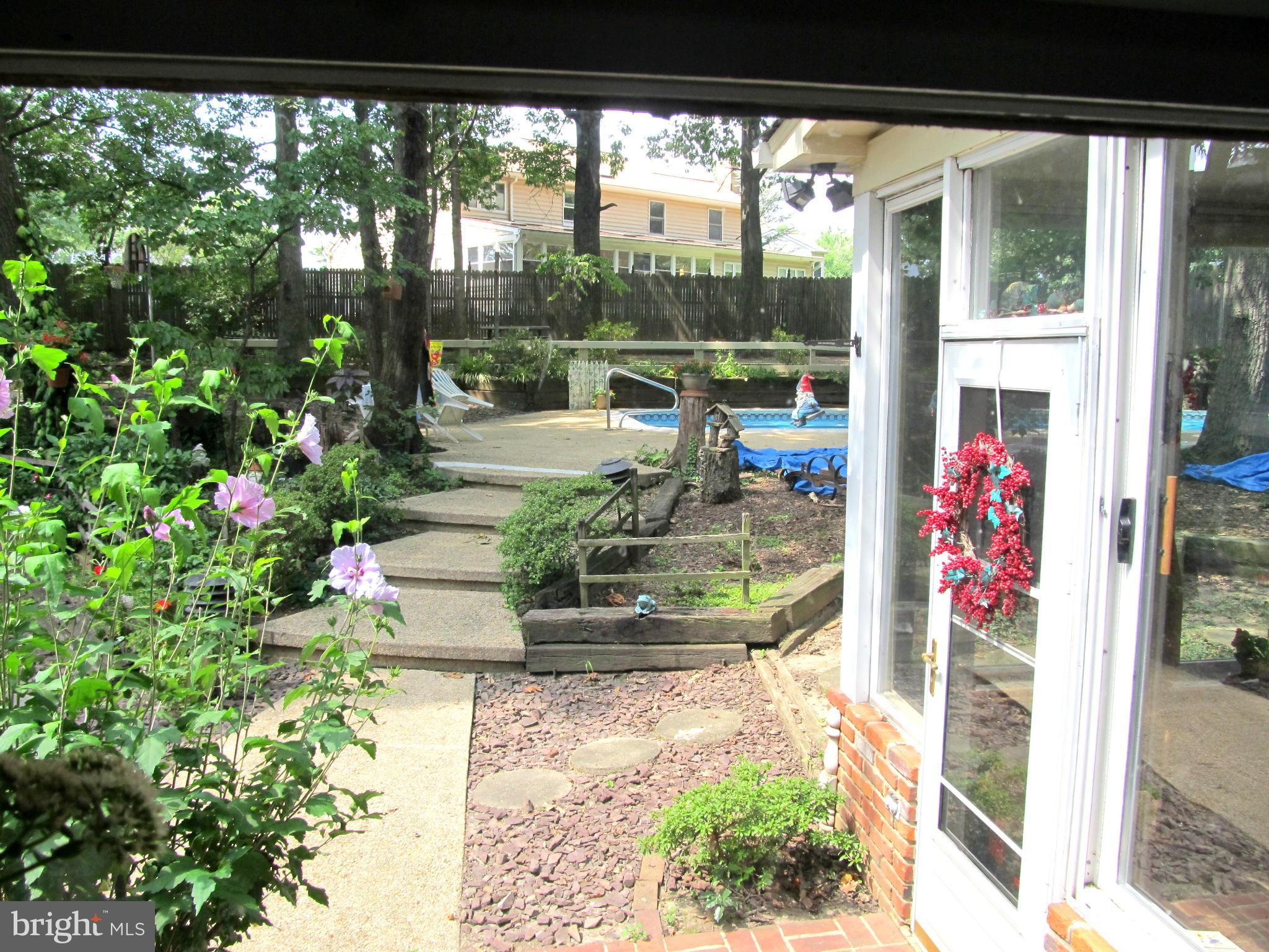 6206 Medora Road Linthicum, MD 21090 - Photo 5 of 30 a view of a porch with chairs and potted plants