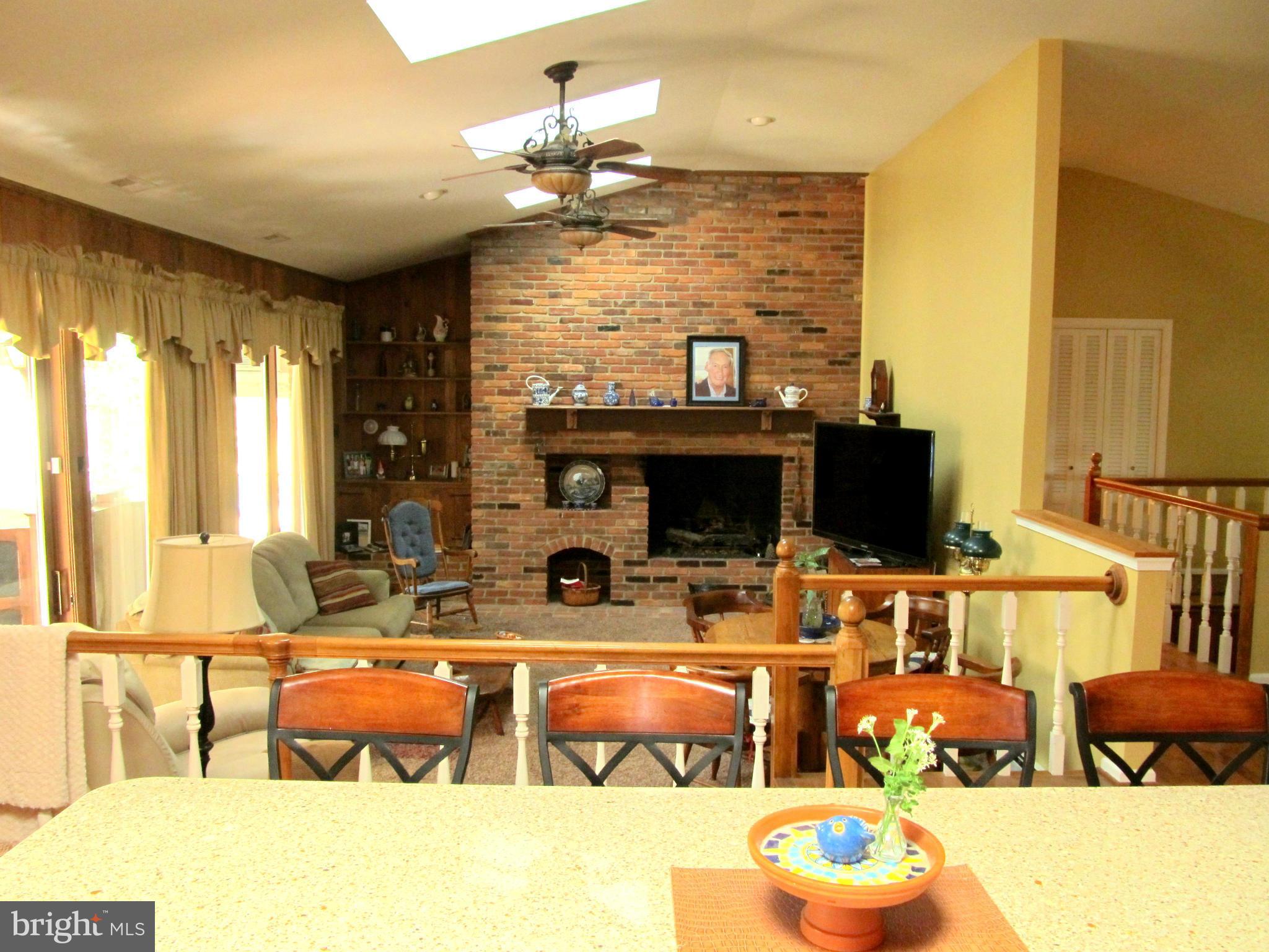6206 Medora Road Linthicum, MD 21090 - Photo 6 of 30 a living room with furniture a flat screen tv and a large window