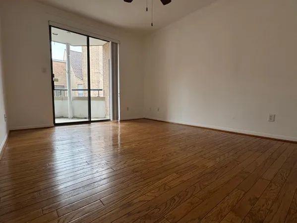 a view of wooden floor and windows in a room