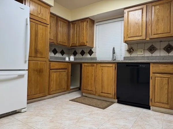 a kitchen with stainless steel appliances granite countertop a refrigerator and cabinets
