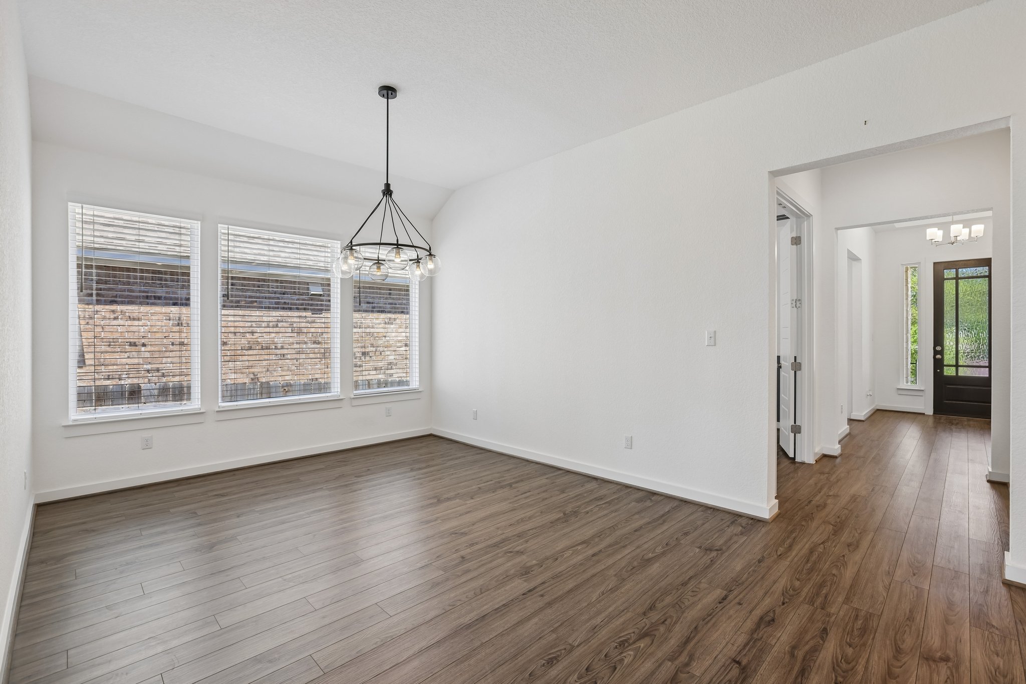 317 Independence Drive Kyle, TX 78640 - Photo 6 of 40 a view of a room with wooden floor closet and windows