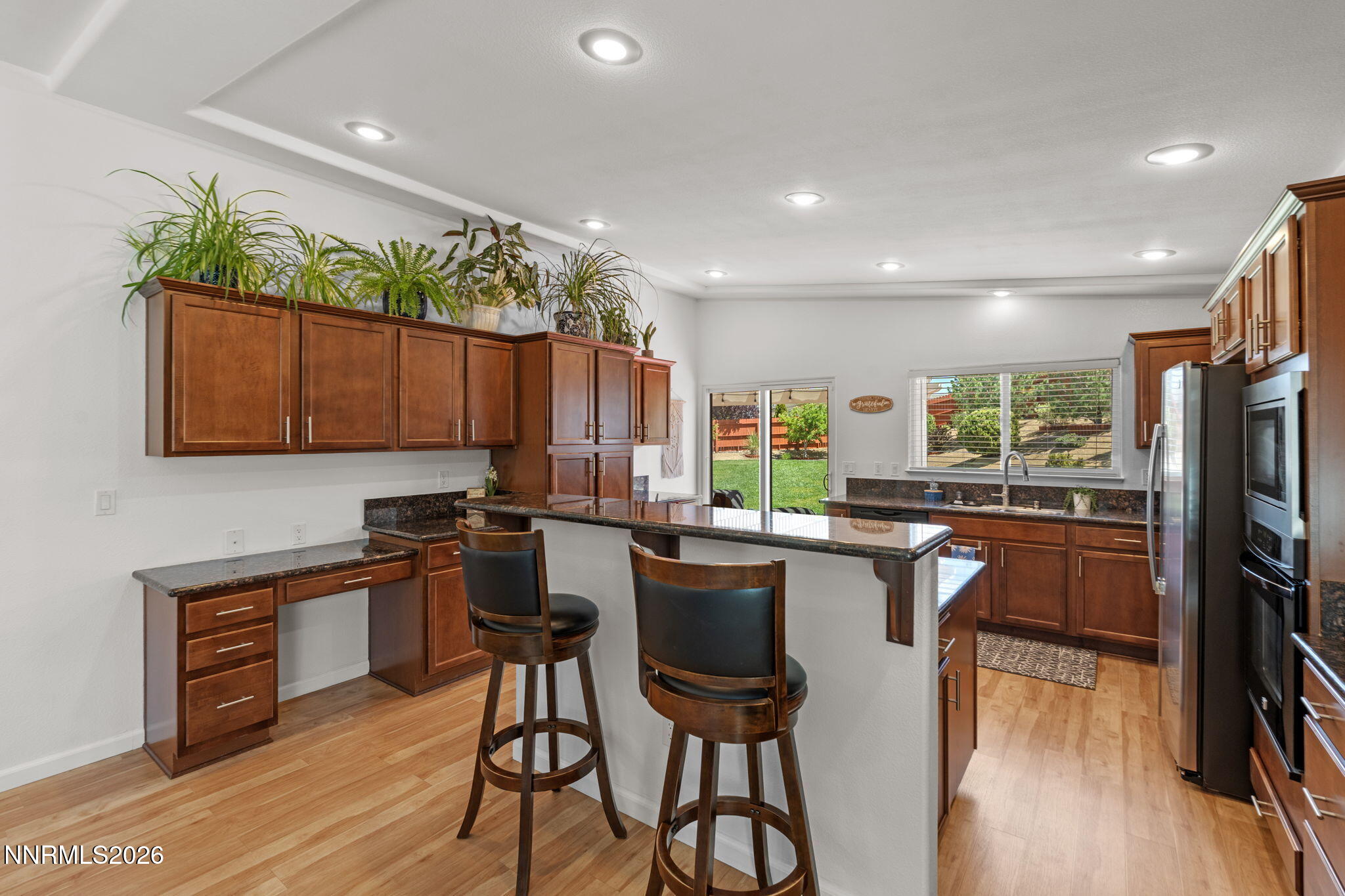 18324 Panda Bear Court Reno, NV 89508 - Photo 44 of 44 a kitchen with a table chairs refrigerator and microwave