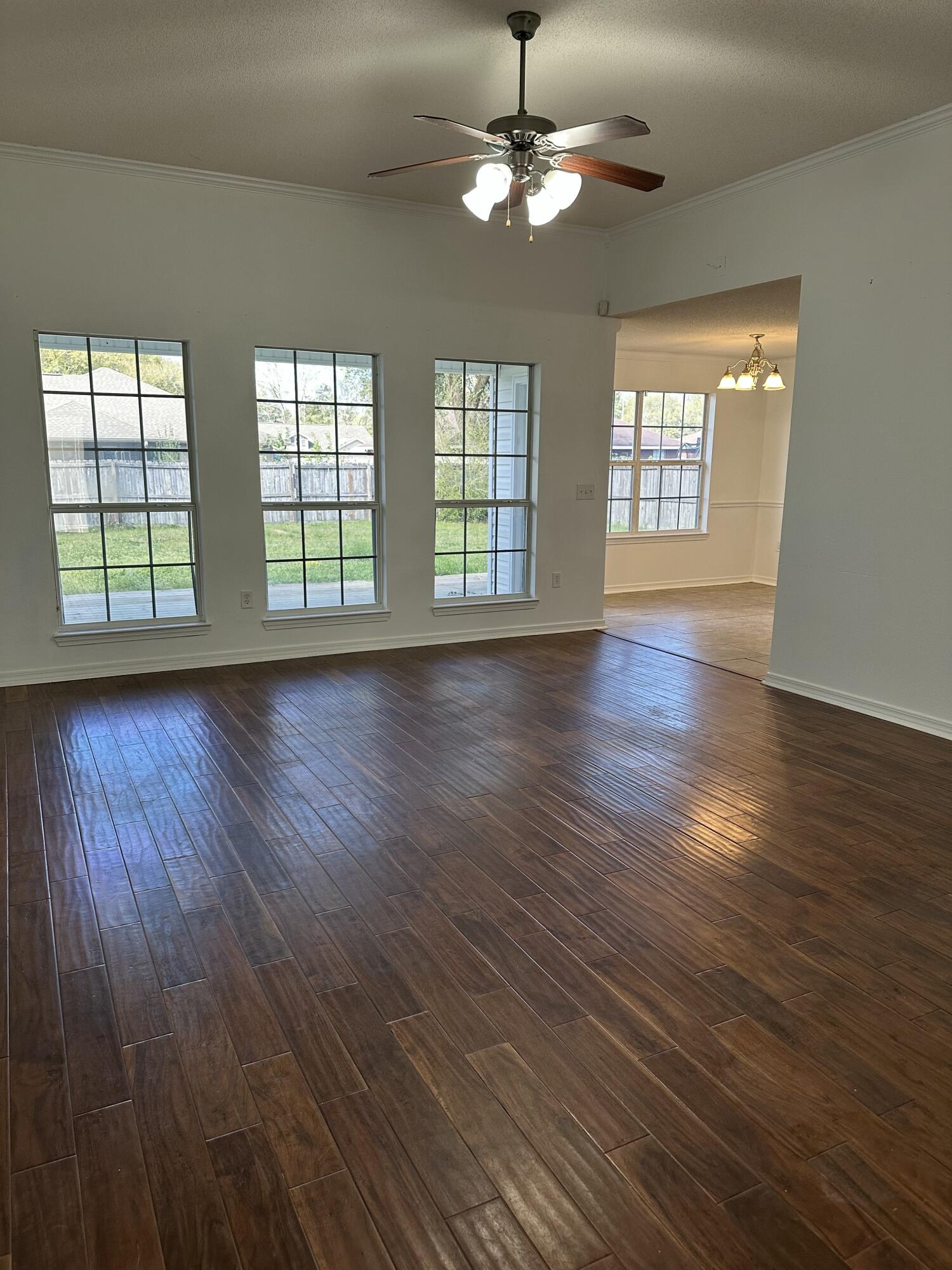 4195 Berry Circle Pace, FL 32571 - Photo 16 of 50 a view of an empty room with wooden floor and a window