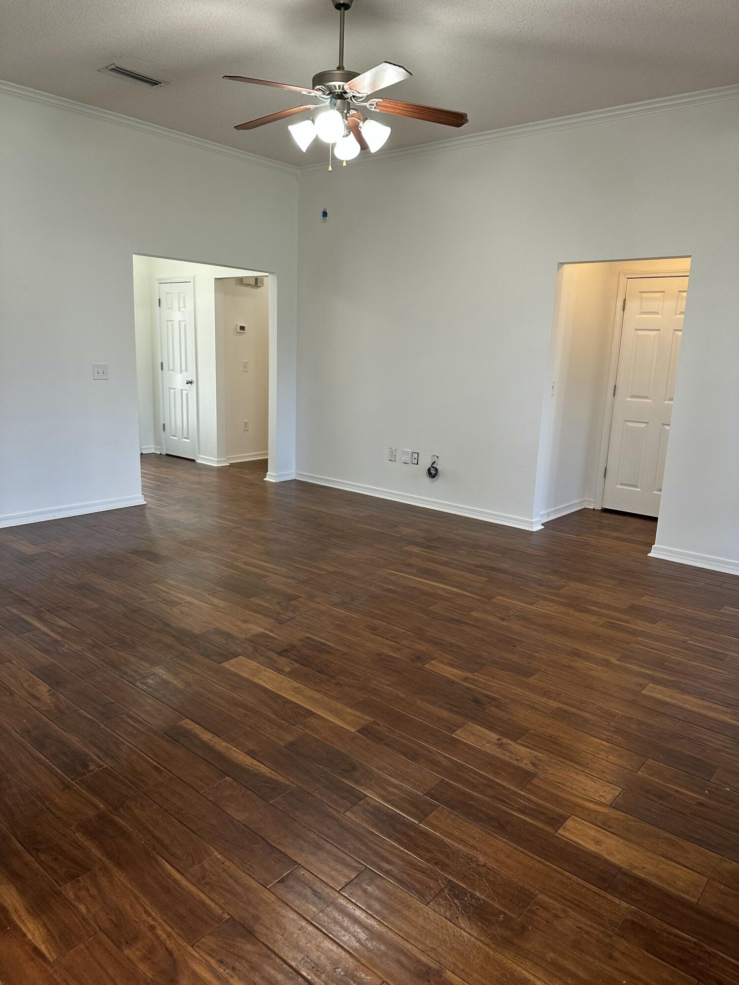 4195 Berry Circle Pace, FL 32571 - Photo 17 of 50 a view of a room with wooden floor and a ceiling fan