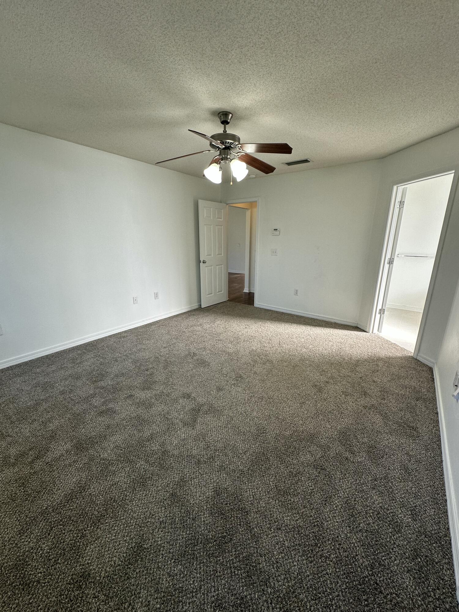 4195 Berry Circle Pace, FL 32571 - Photo 19 of 50 an empty room with a ceiling fan and a window