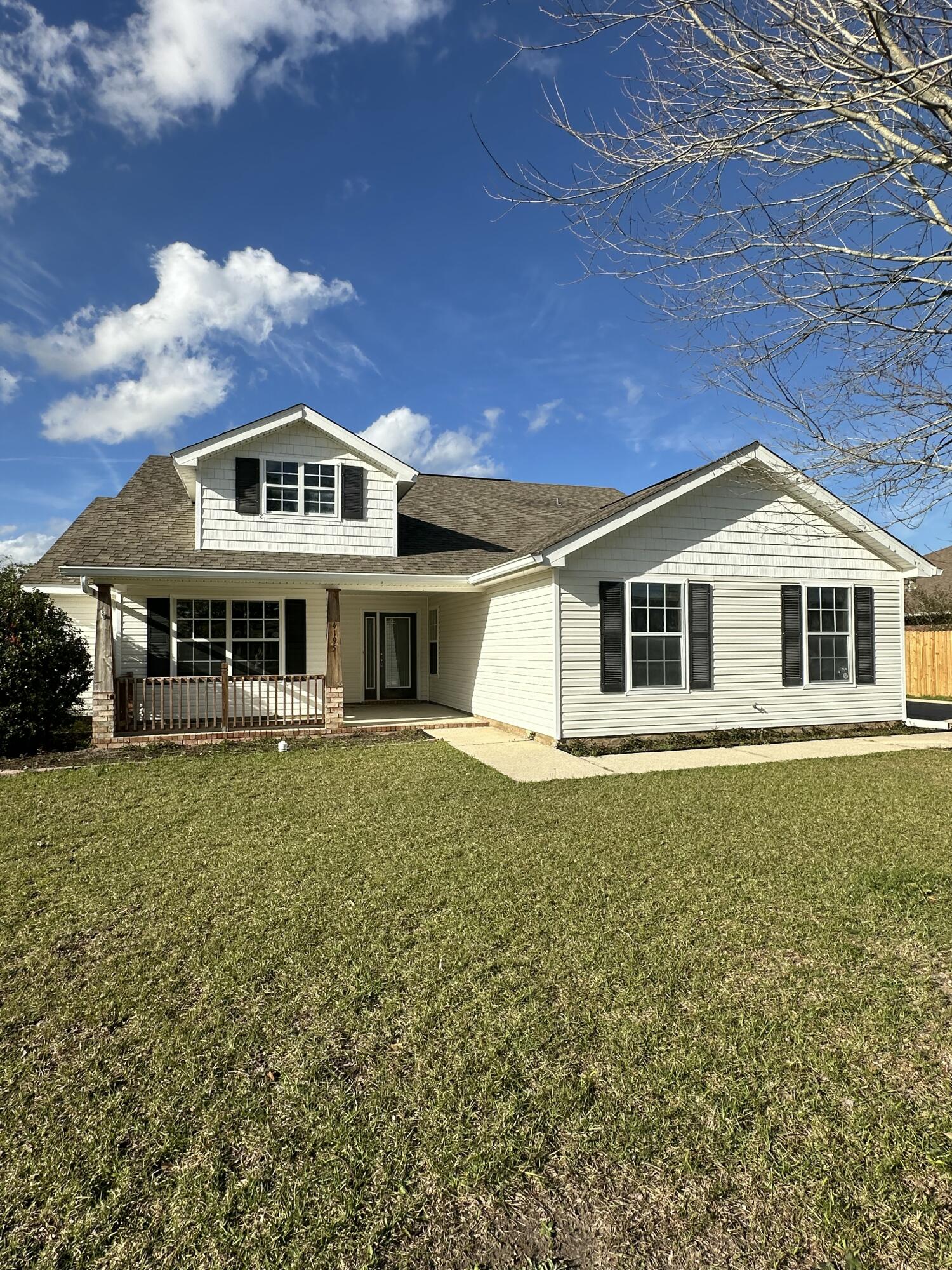 4195 Berry Circle Pace, FL 32571 - Photo 2 of 50 a front view of a house with a garden