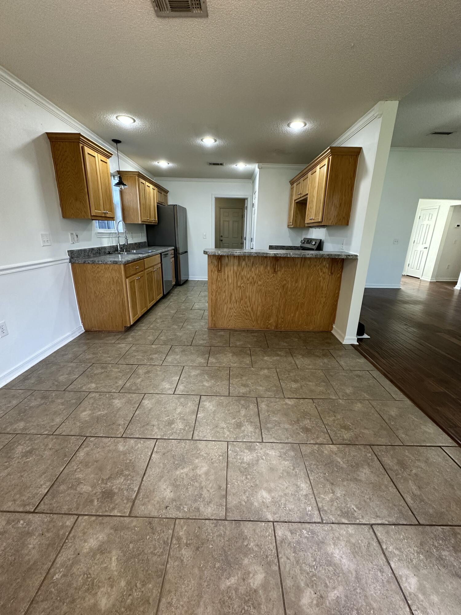 4195 Berry Circle Pace, FL 32571 - Photo 31 of 50 a view of kitchen with stainless steel appliances kitchen island granite countertop a sink cabinets and window
