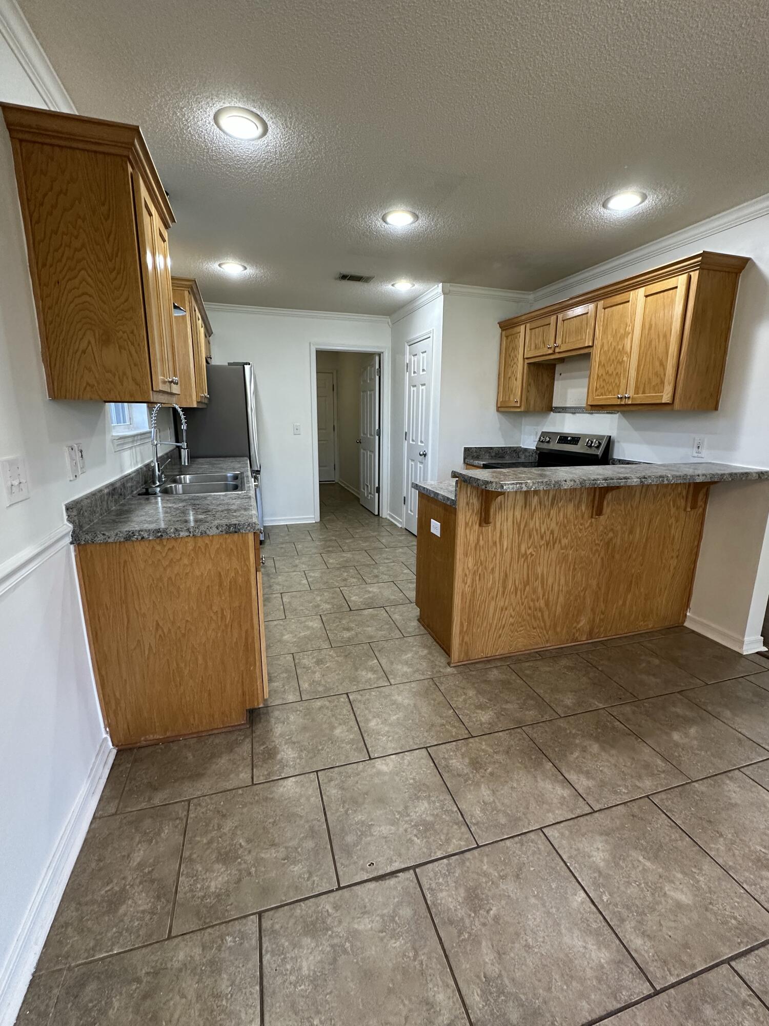 4195 Berry Circle Pace, FL 32571 - Photo 32 of 50 a kitchen with stainless steel appliances granite countertop a sink and a stove