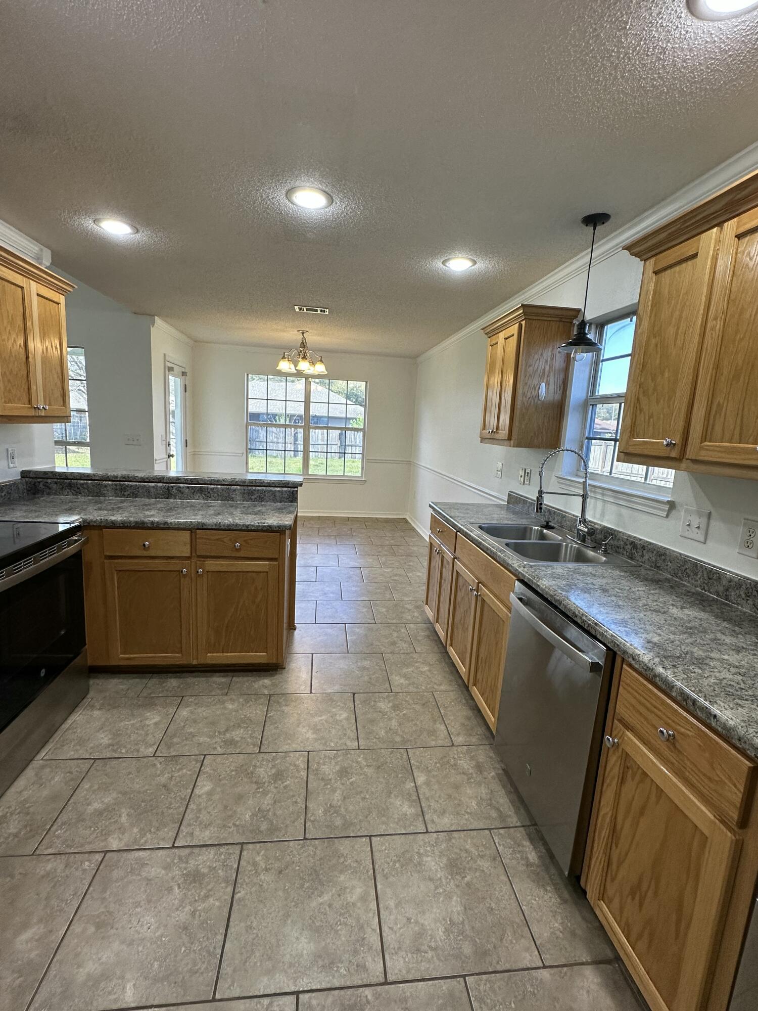 4195 Berry Circle Pace, FL 32571 - Photo 33 of 50 a kitchen with a sink a counter top space cabinets and stainless steel appliances