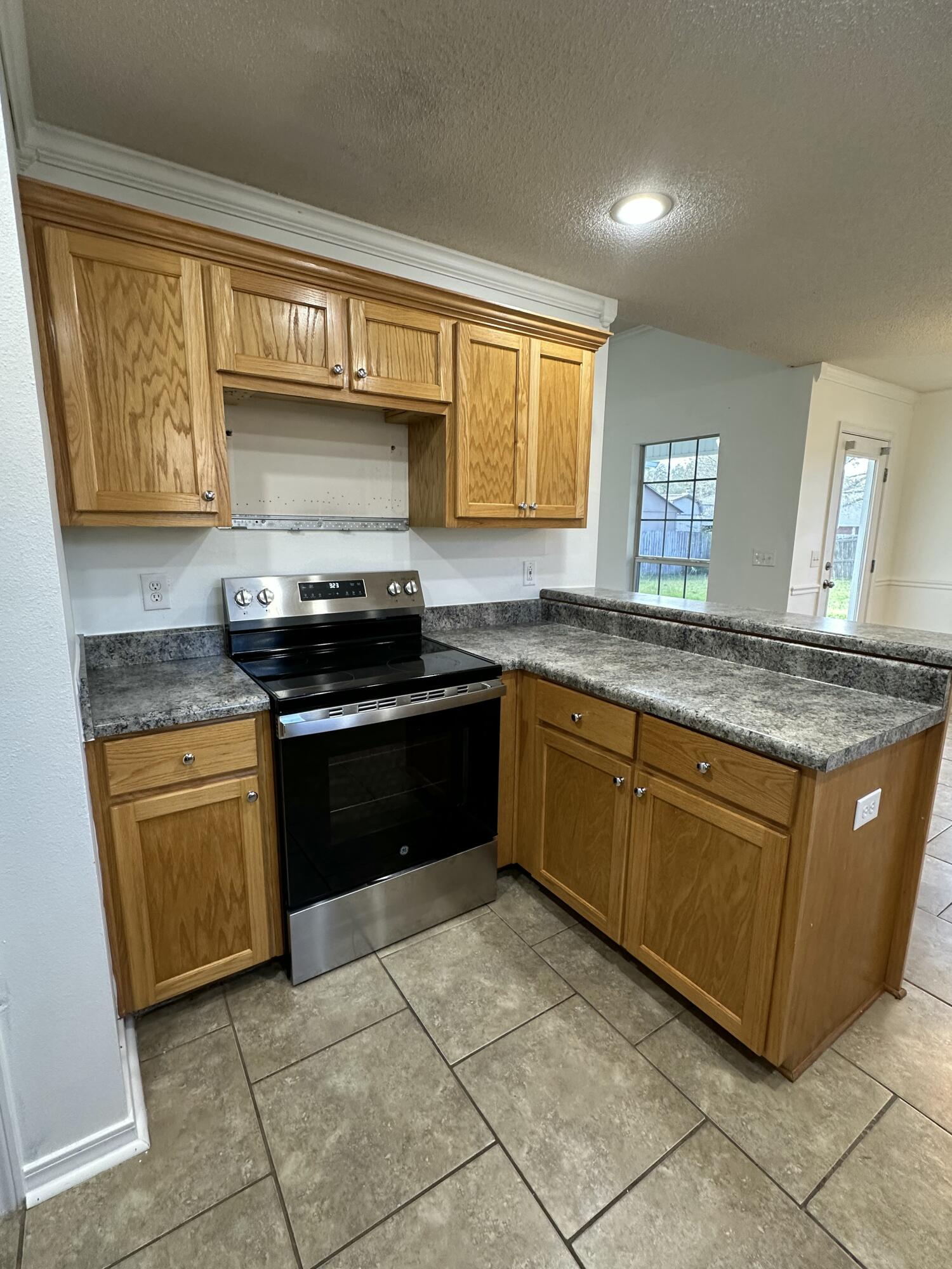 4195 Berry Circle Pace, FL 32571 - Photo 38 of 50 a kitchen with granite countertop a sink a counter top space cabinets and stainless steel appliances