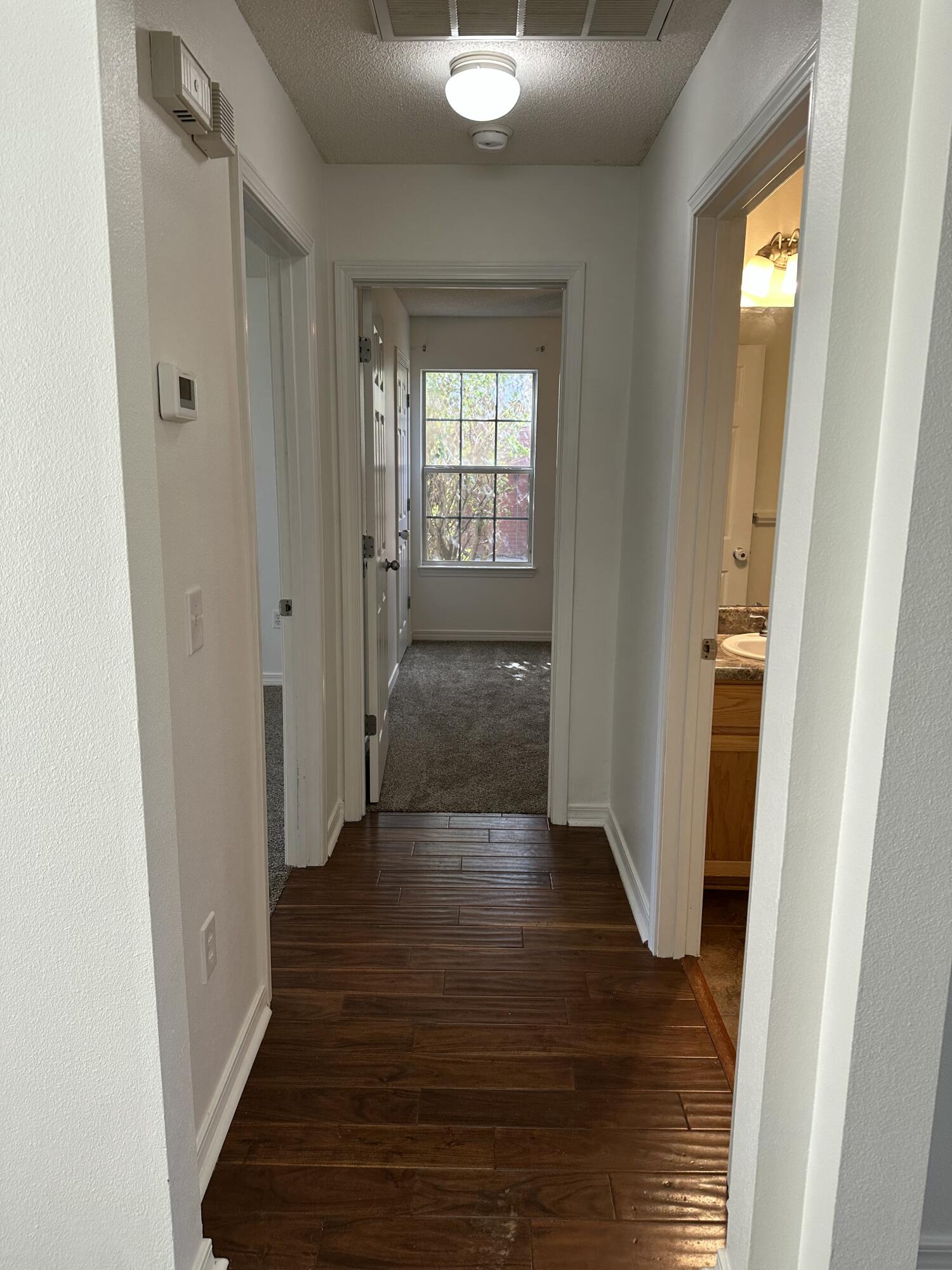 4195 Berry Circle Pace, FL 32571 - Photo 9 of 50 a view of a hallway with wooden floor and staircase