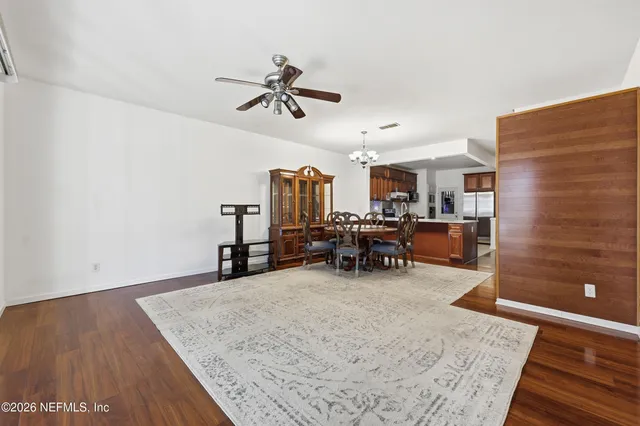 a view of a livingroom with furniture and hardwood floor