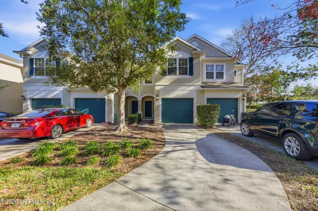a view of a house with a yard covered in snow