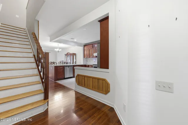a view of a kitchen with wooden floor and a sink