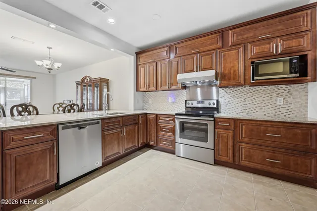 a kitchen with granite countertop stainless steel appliances and cabinets