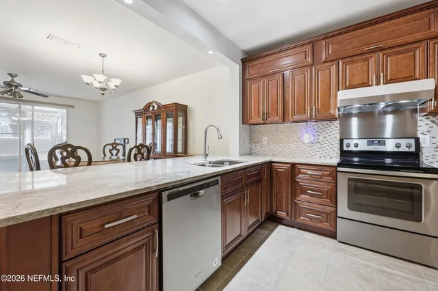 a kitchen with granite countertop a stove and a sink