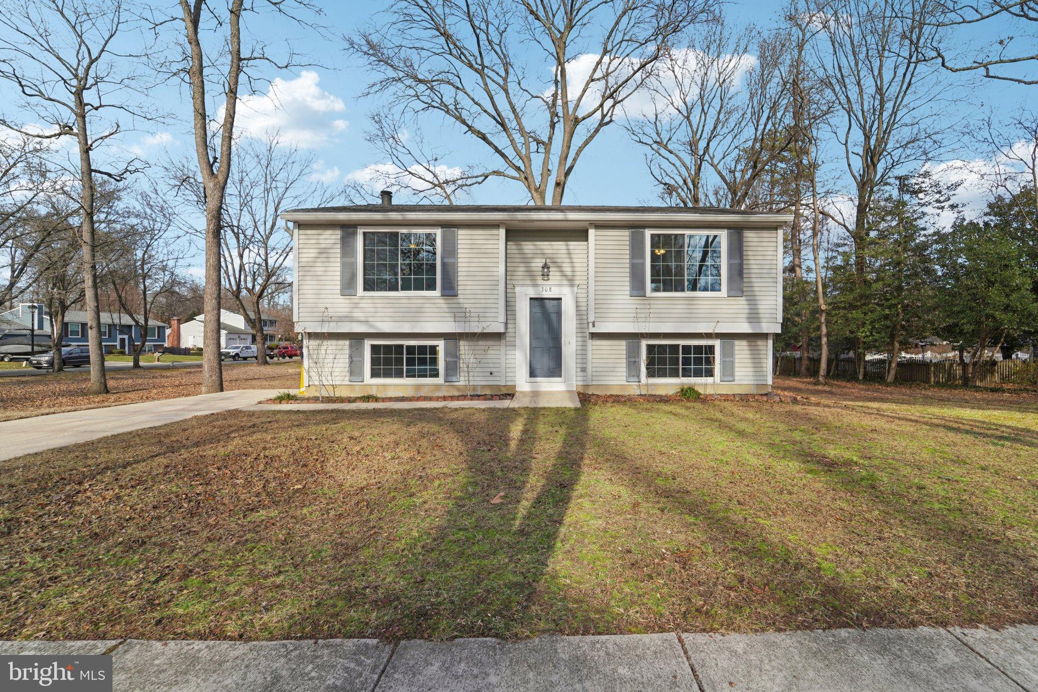 308 Raussell Place Severna Park, MD 21146 - Photo 1 of 31 a front view of a house with large trees