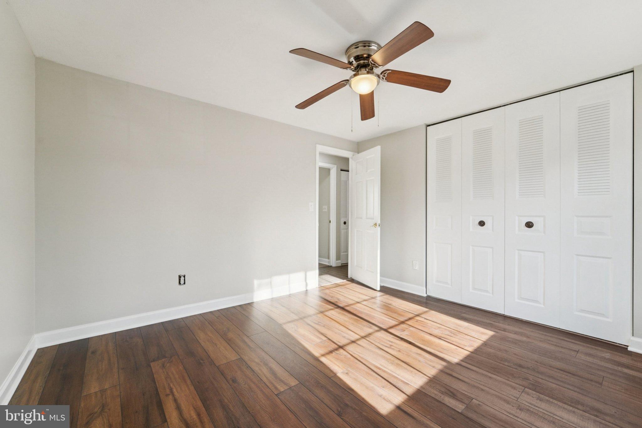 308 Raussell Place Severna Park, MD 21146 - Photo 12 of 31 an empty room with wooden floor and windows