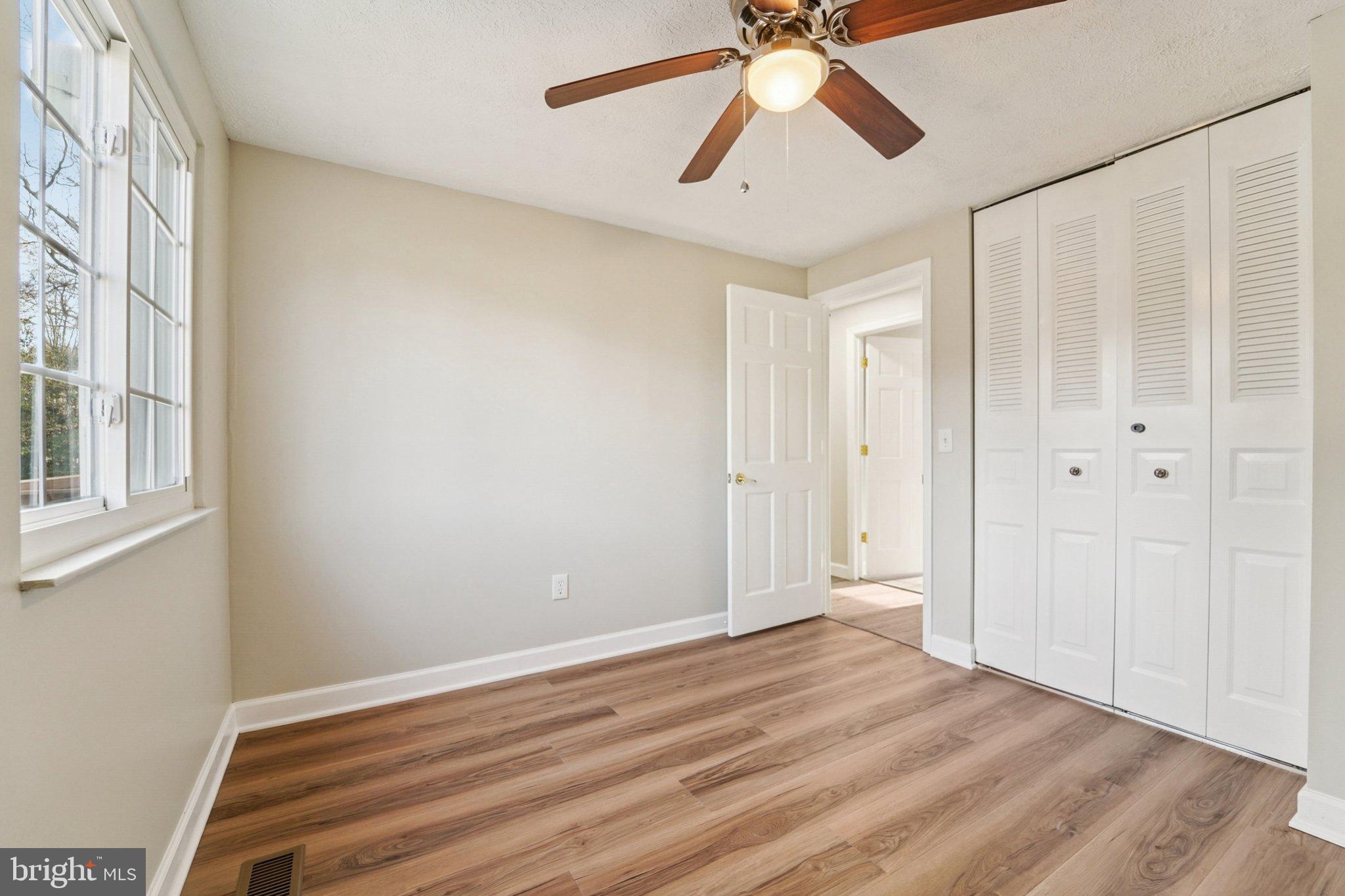 308 Raussell Place Severna Park, MD 21146 - Photo 13 of 31 wooden floor in an empty room with a window