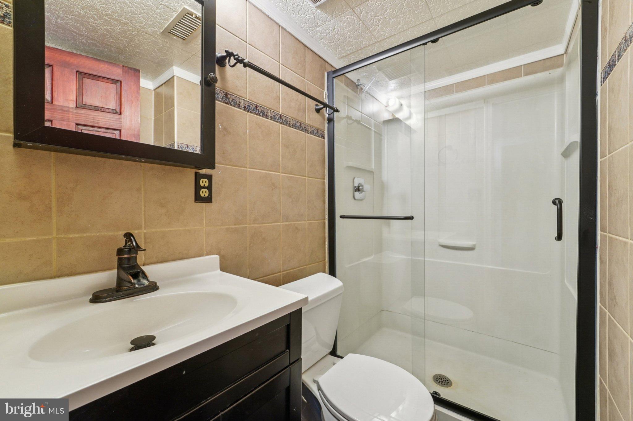 308 Raussell Place Severna Park, MD 21146 - Photo 18 of 31 a bathroom with a sink toilet and shower