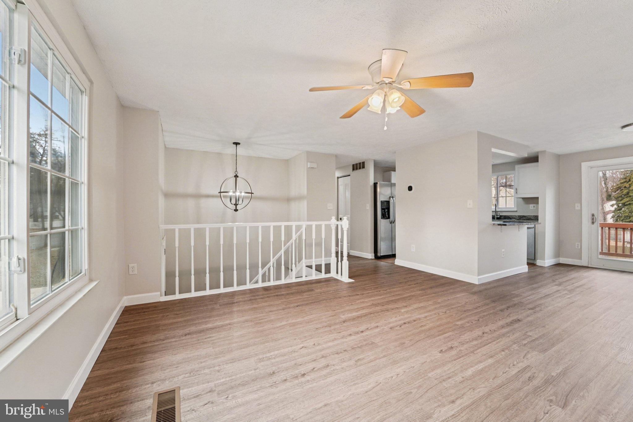 308 Raussell Place Severna Park, MD 21146 - Photo 2 of 31 a view of a livingroom with wooden floor and staircase