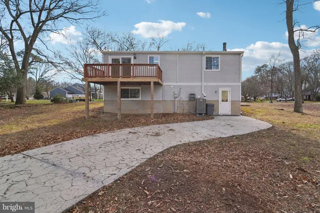 a view of a house with a yard covered in snow
