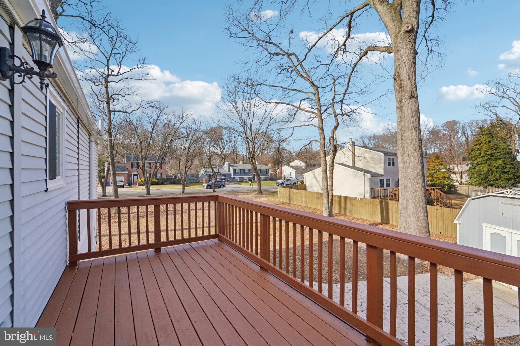 308 Raussell Place Severna Park, MD 21146 - Photo 25 of 31 a view of a wooden deck with large trees