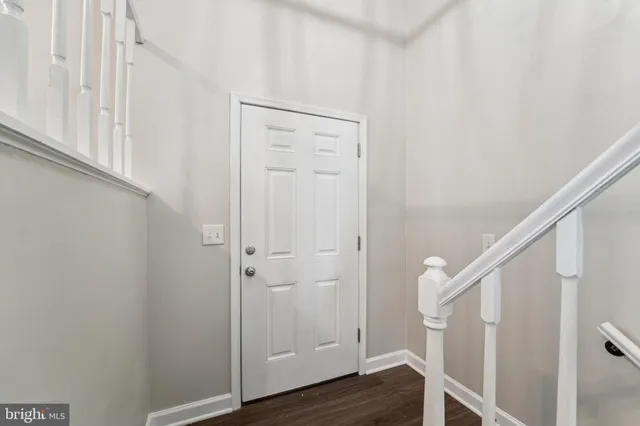 a view of front door with wooden floor
