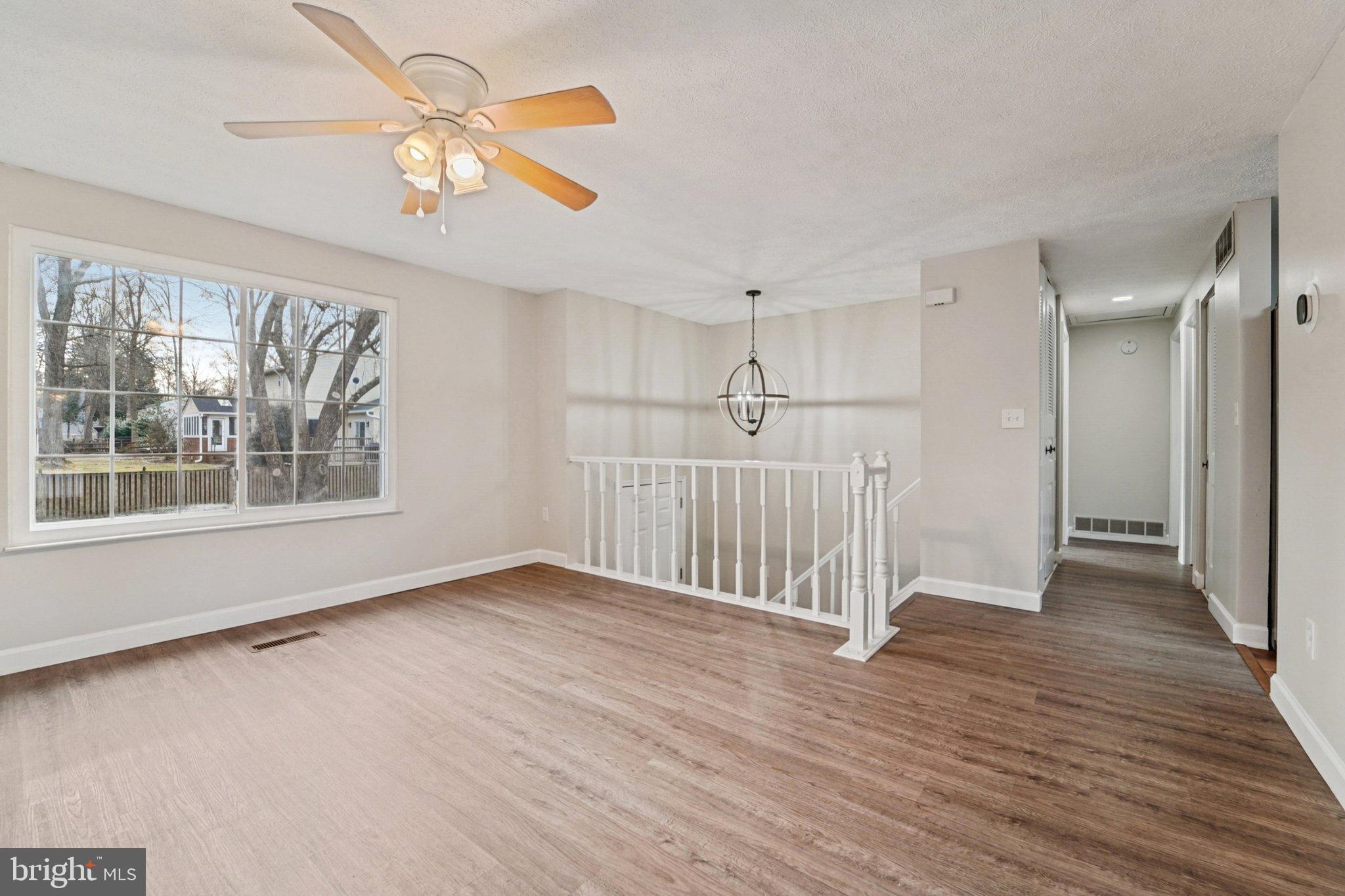 308 Raussell Place Severna Park, MD 21146 - Photo 5 of 31 a view of an empty room with wooden floor and a window