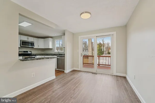 a kitchen with granite countertop a stove a sink and a refrigerator