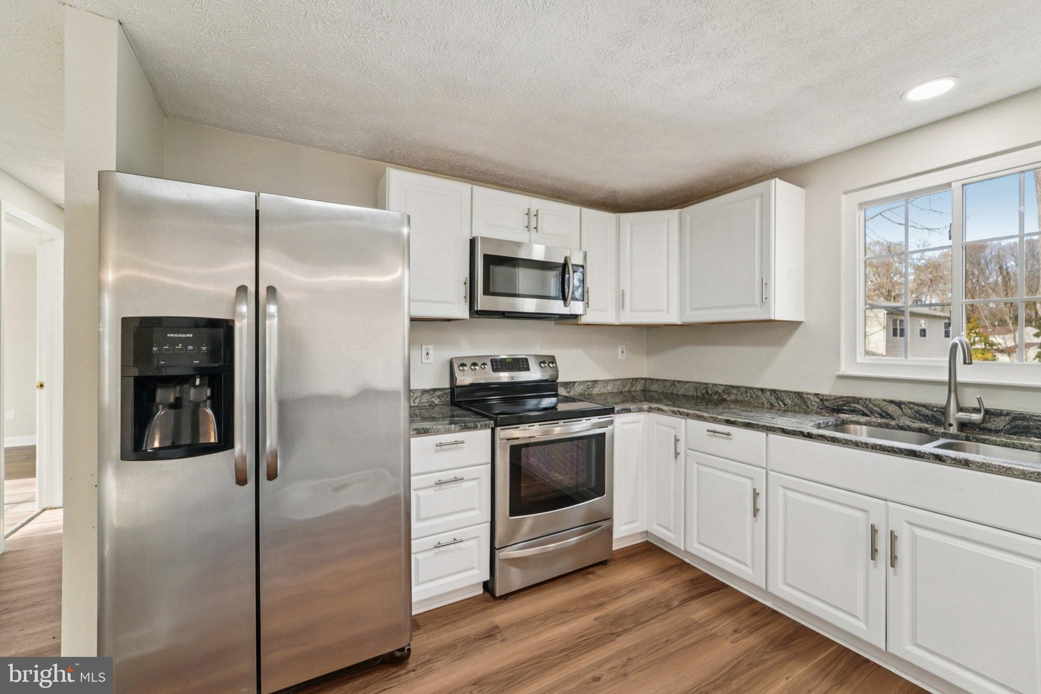 308 Raussell Place Severna Park, MD 21146 - Photo 8 of 31 a kitchen with stainless steel appliances granite countertop a refrigerator and a stove top oven