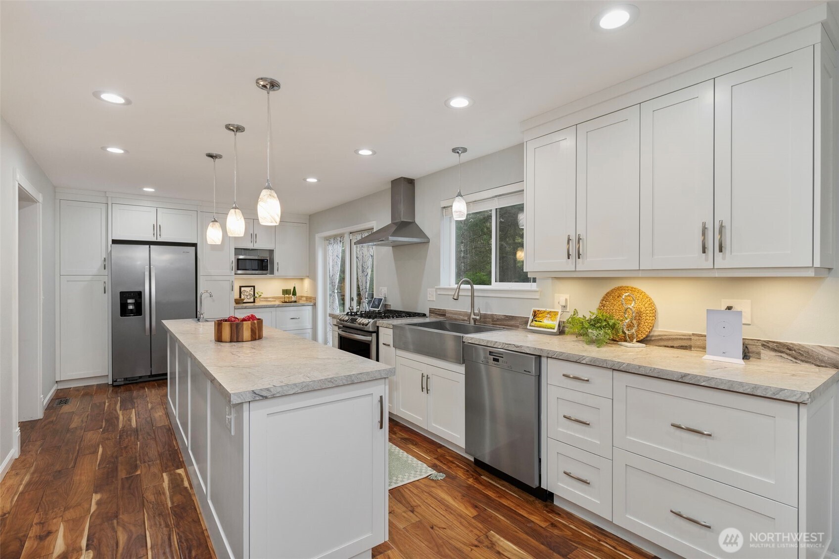 15219 Wright Bliss Road Northwest Gig Harbor, WA 98329 - Photo 13 of 39 a kitchen with white cabinets and stainless steel appliances