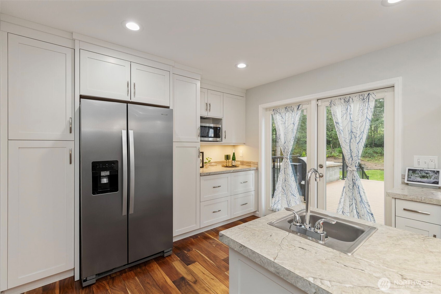 15219 Wright Bliss Road Northwest Gig Harbor, WA 98329 - Photo 14 of 39 a kitchen with stainless steel appliances granite countertop a refrigerator and a sink