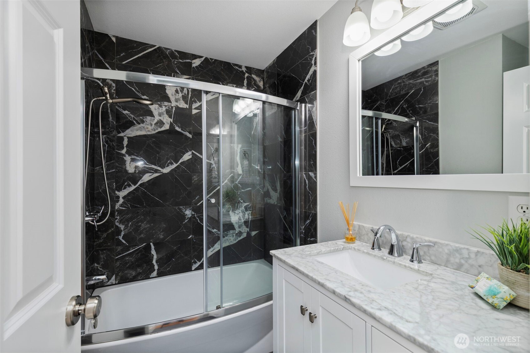 15219 Wright Bliss Road Northwest Gig Harbor, WA 98329 - Photo 28 of 39 a bathroom with a granite countertop sink a mirror and shower