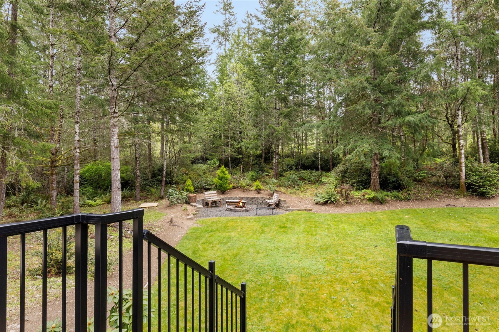 15219 Wright Bliss Road Northwest Gig Harbor, WA 98329 - Photo 32 of 39 a view of swimming pool with lawn chairs and plants
