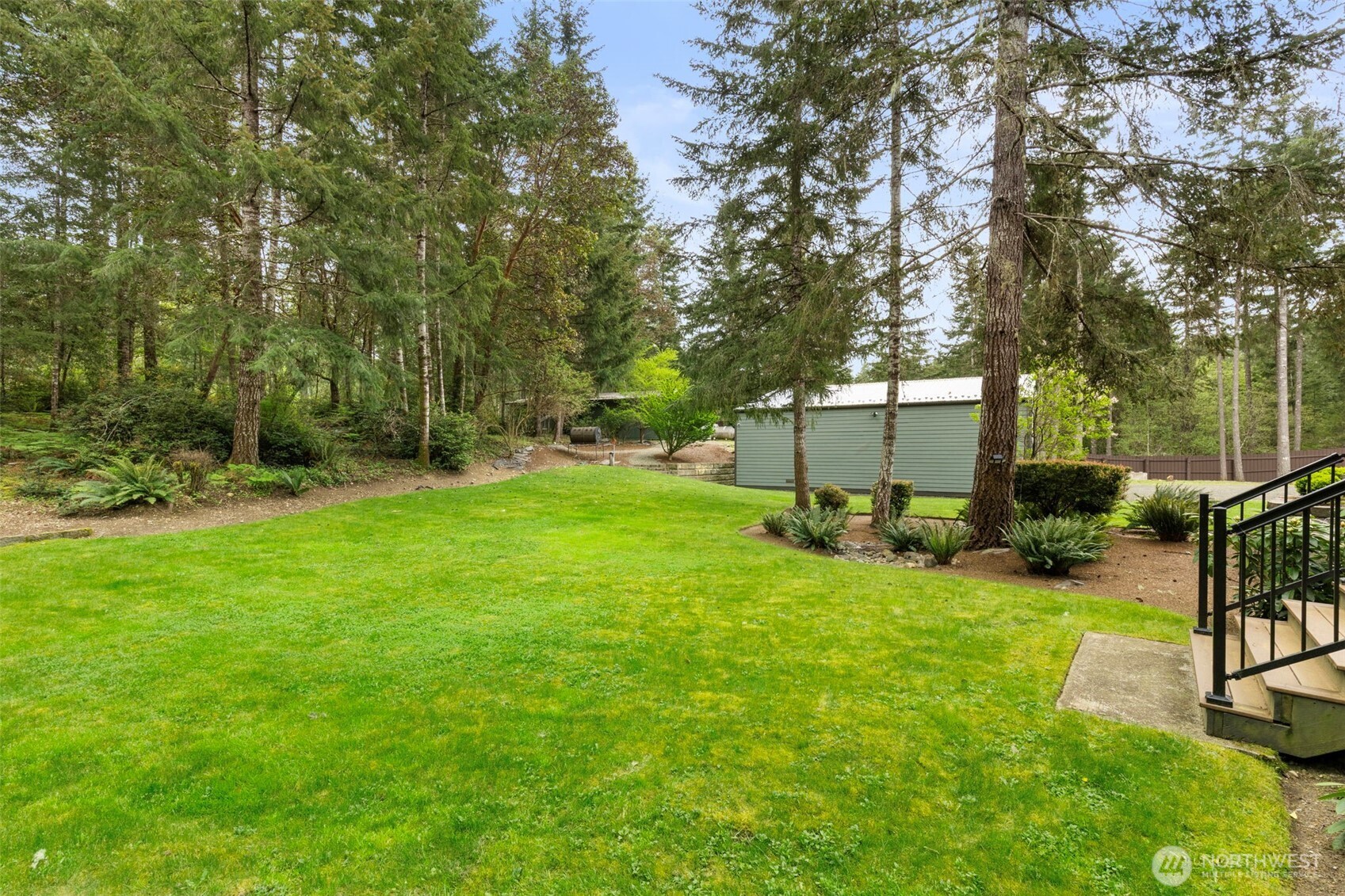 15219 Wright Bliss Road Northwest Gig Harbor, WA 98329 - Photo 34 of 39 a view of a backyard with a garden and trees