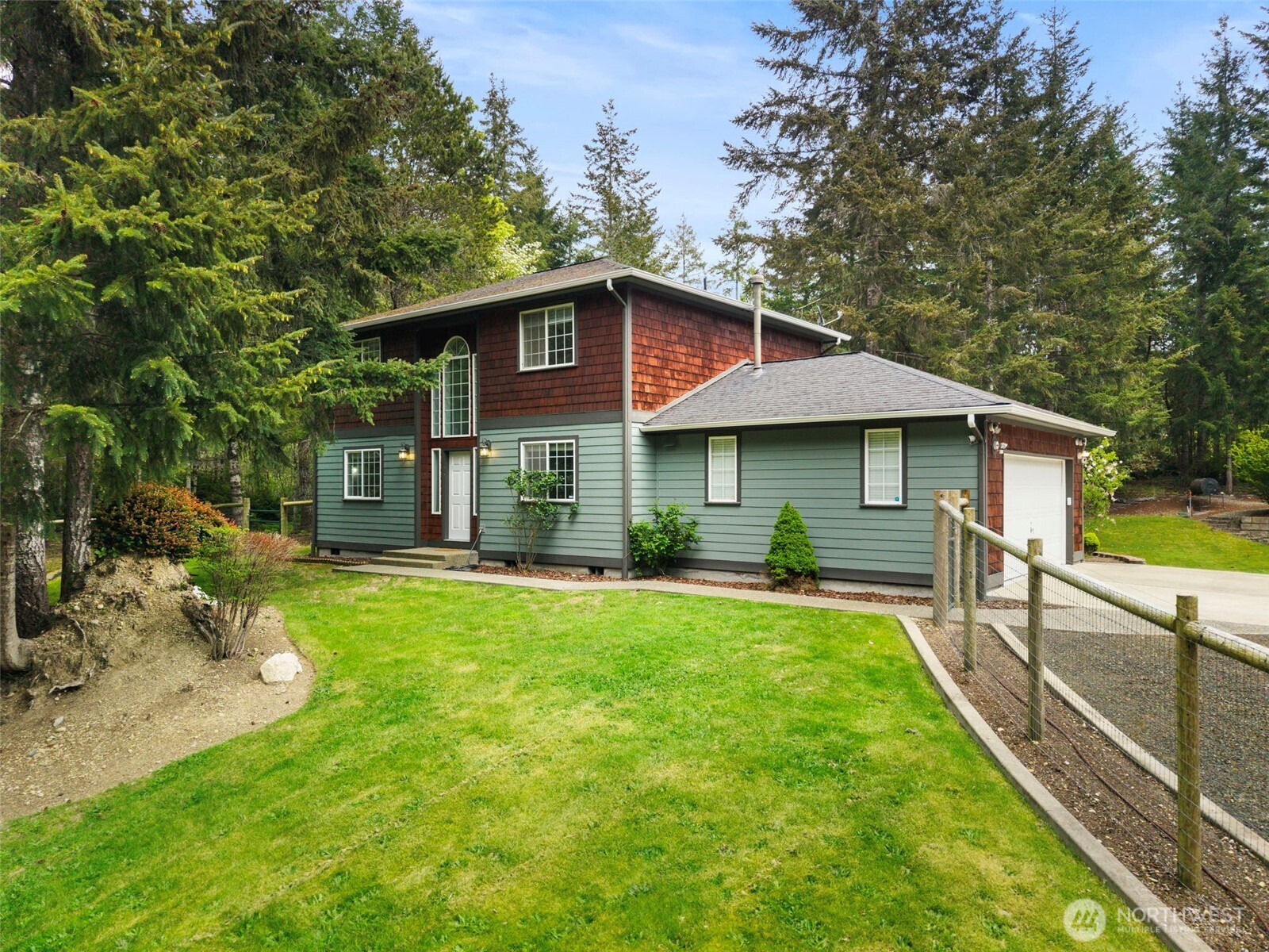 15219 Wright Bliss Road Northwest Gig Harbor, WA 98329 - Photo 5 of 39 a front view of a house with a yard