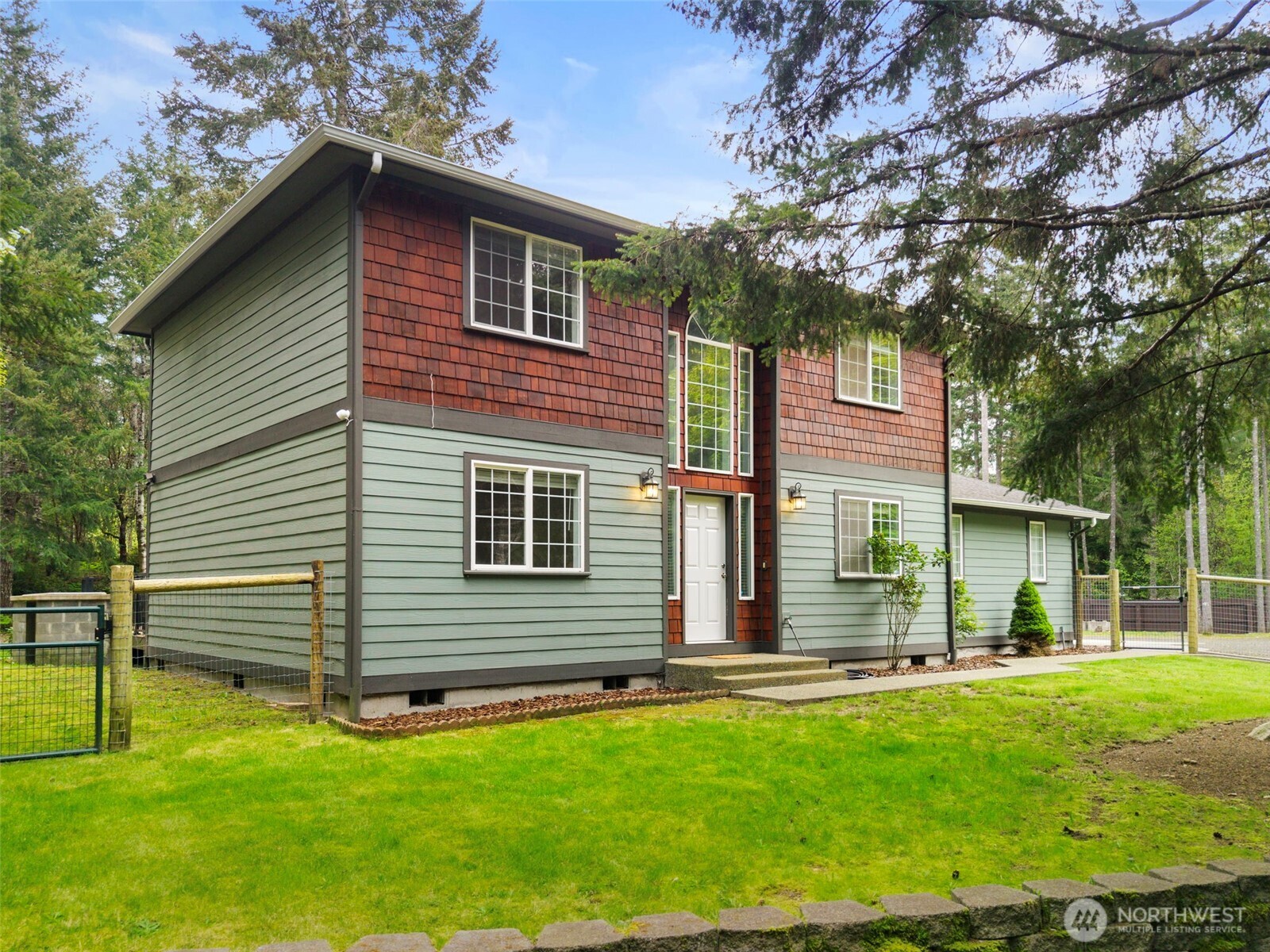 15219 Wright Bliss Road Northwest Gig Harbor, WA 98329 - Photo 6 of 39 a front view of a house with a yard