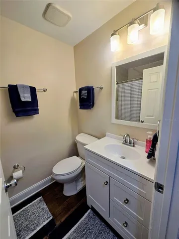 a bathroom with a toilet a sink and mirror