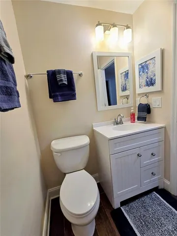 a bathroom with a toilet sink and mirror