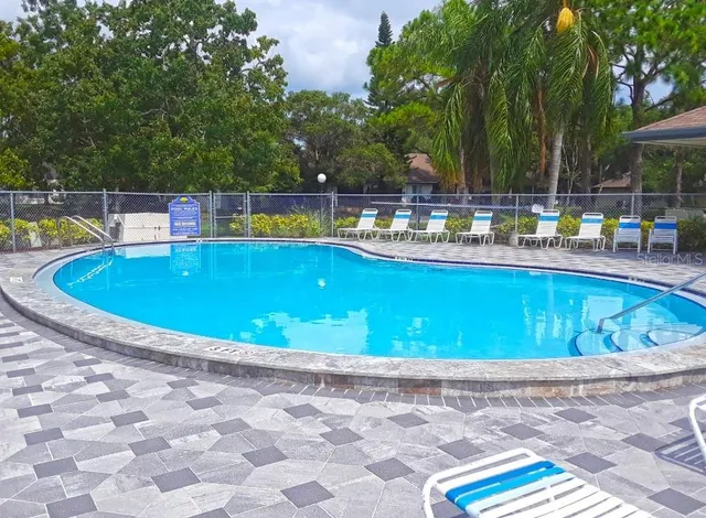 a view of swimming pool with chairs