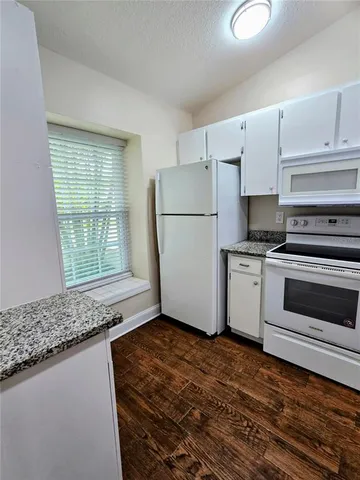 a kitchen with a refrigerator stove and cabinets