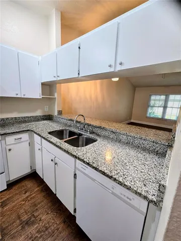 a kitchen with a sink and cabinets