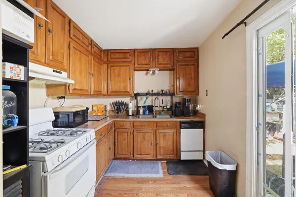 a kitchen with stainless steel appliances a stove a sink and a refrigerator