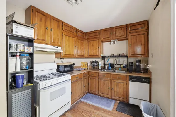 a kitchen with stainless steel appliances granite countertop a stove and cabinets